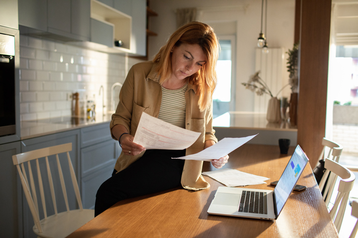 A woman going over tax documents for her LLC.