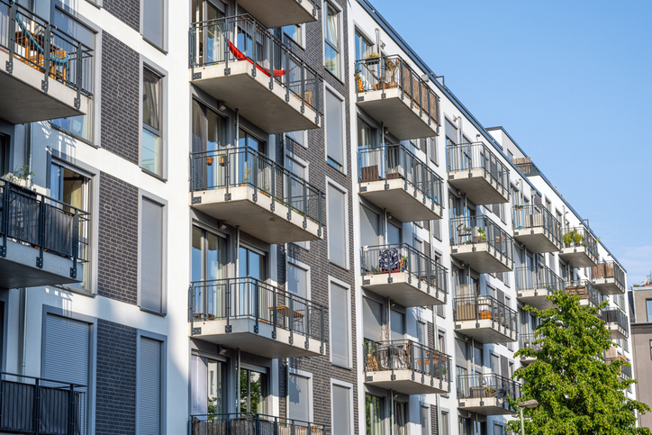 A multi-family apartment building with private terraces. 